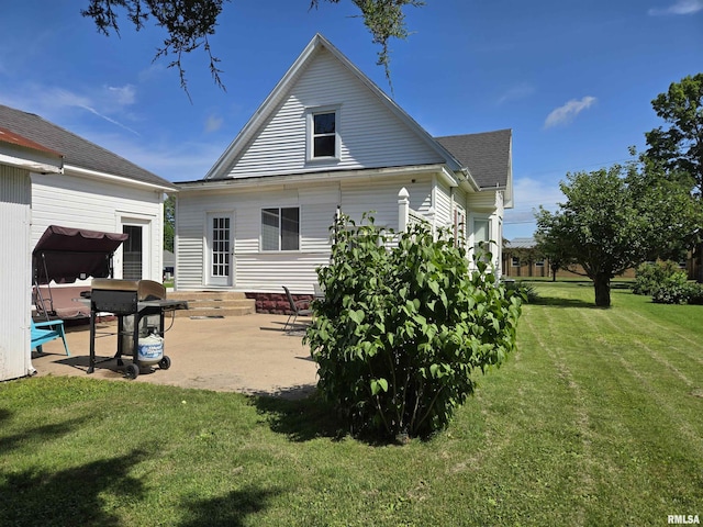 505 W Main St, La Harpe, IL 61450 - rear view of property with a patio, a yard, and a shingled roof