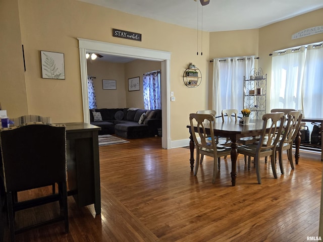 dining room featuring dark hardwood / wood-style floors and ceiling fan