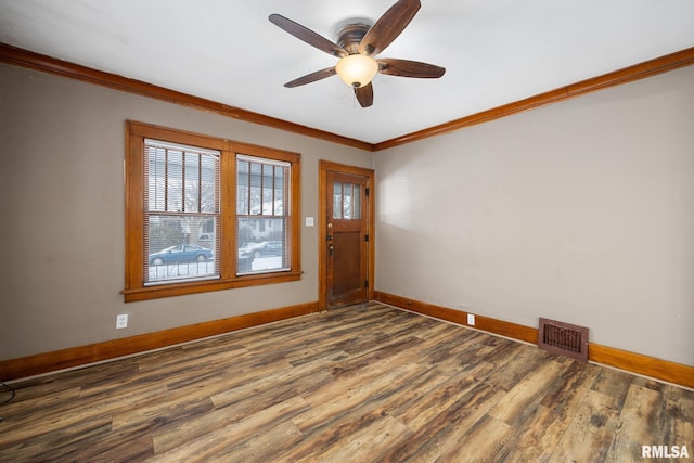 spare room with hardwood / wood-style floors, ceiling fan, and ornamental molding