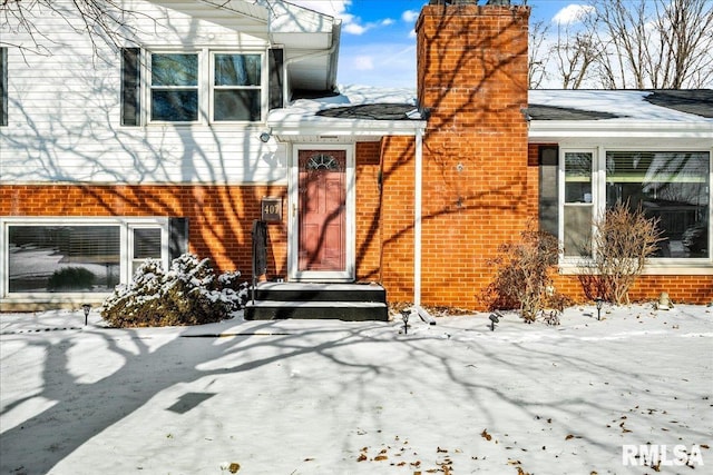 view of snow covered property entrance