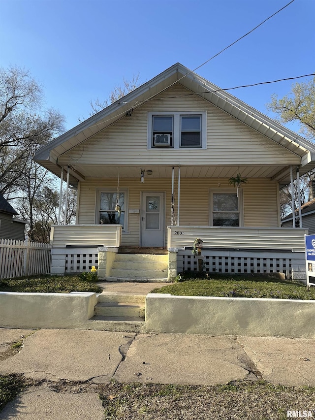 bungalow-style home featuring fence and covered porch