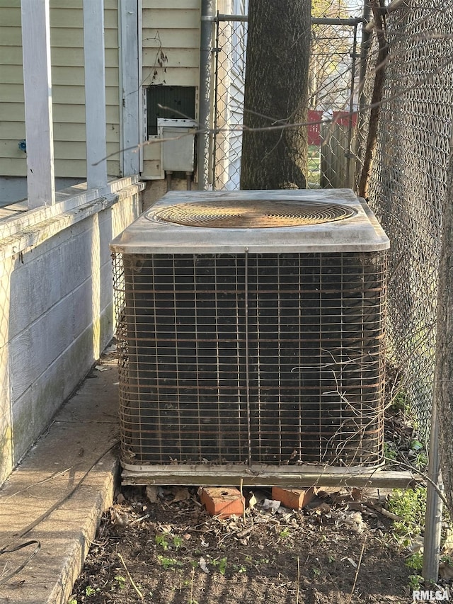 exterior details featuring central air condition unit and fence