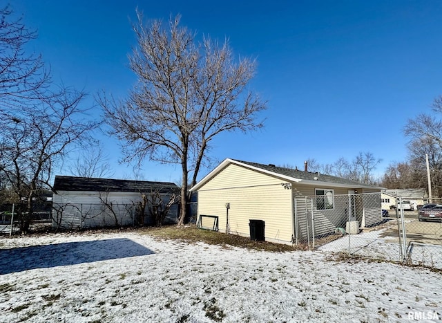 view of snow covered rear of property