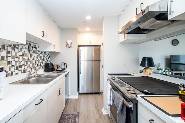 kitchen featuring backsplash, white cabinetry, sink, and appliances with stainless steel finishes