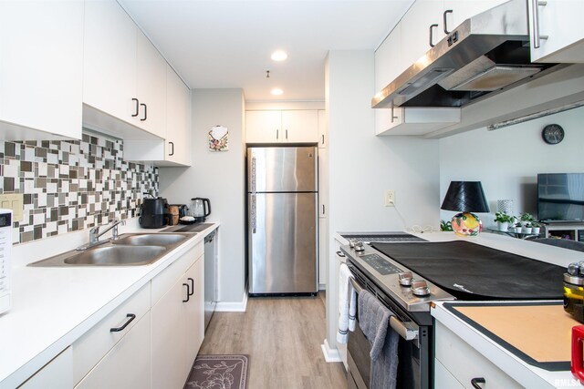 123 SW Jefferson St Unit E4W, Peoria, IL 61602 - kitchen with stainless steel appliances, ventilation hood, light wood finished floors, light countertops, and recessed lighting