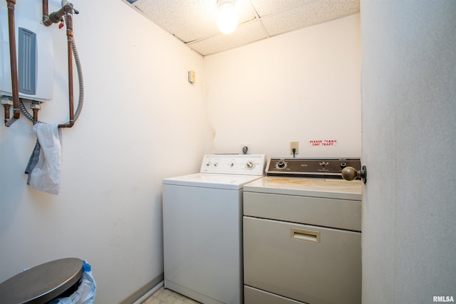 washroom featuring water heater and washing machine and clothes dryer