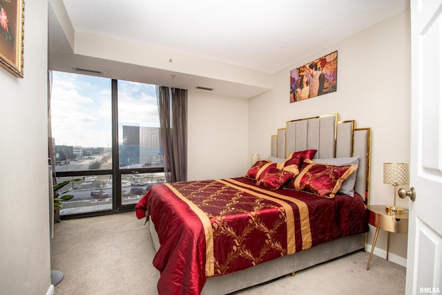 carpeted bedroom with expansive windows