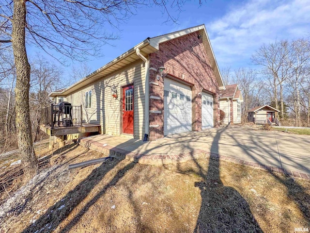 view of home's exterior featuring a garage and a wooden deck