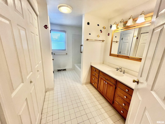 bathroom featuring tile patterned flooring and vanity