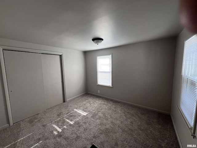 unfurnished bedroom with a closet and carpet floors