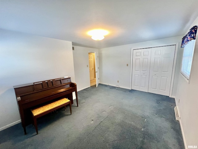 misc room featuring dark carpet and baseboard heating