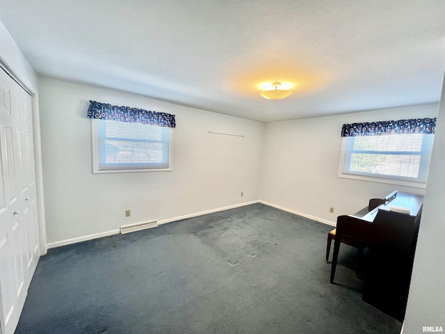 unfurnished room featuring dark colored carpet