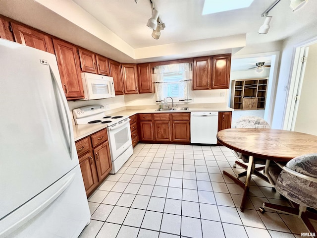 kitchen featuring light tile patterned flooring, white appliances, ceiling fan, and sink