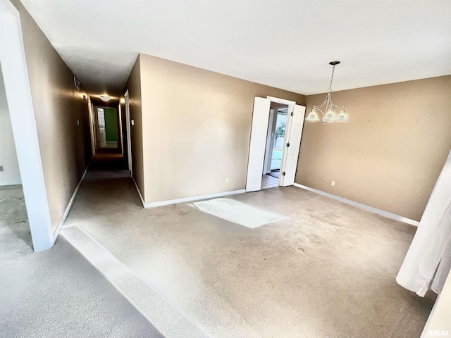 empty room featuring an inviting chandelier