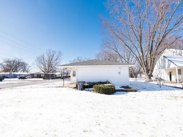 view of snowy exterior featuring an outdoor structure