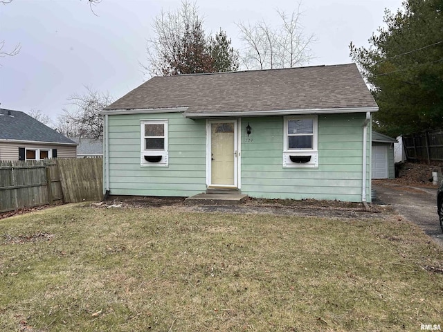 bungalow-style home with a front lawn