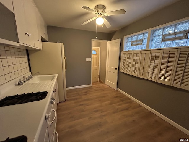 kitchen with white cabinets, white refrigerator, hardwood / wood-style flooring, decorative backsplash, and ceiling fan