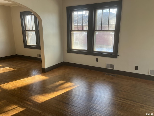 empty room with dark wood-type flooring