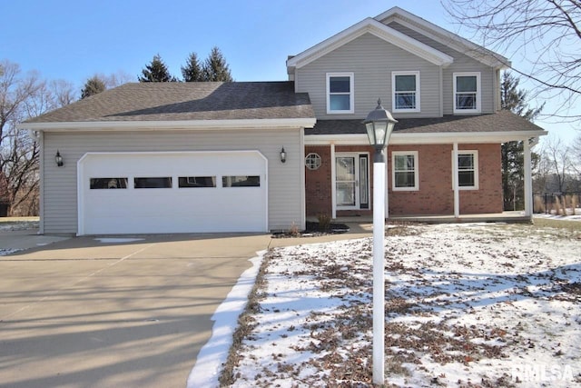 front of property featuring covered porch and a garage