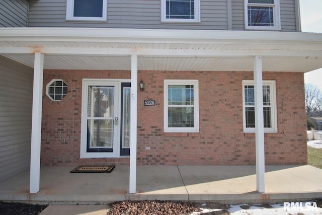 entrance to property featuring a porch