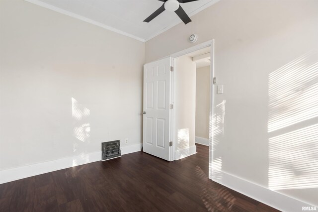 empty room with dark hardwood / wood-style floors, ceiling fan, and crown molding