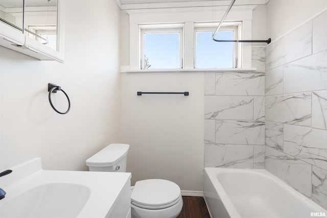 full bathroom with wood-type flooring, vanity, toilet, and tiled shower / bath