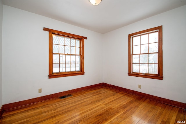 unfurnished room featuring hardwood / wood-style floors