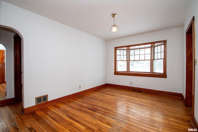 spare room with hardwood / wood-style floors