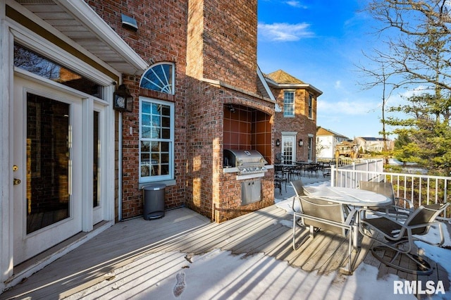 wooden deck with a grill