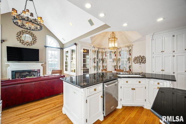 kitchen featuring dishwasher, light hardwood / wood-style floors, white cabinetry, and an inviting chandelier