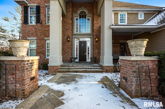 view of snow covered property entrance