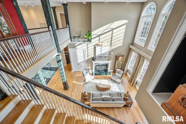 stairs featuring wood-type flooring and a high ceiling