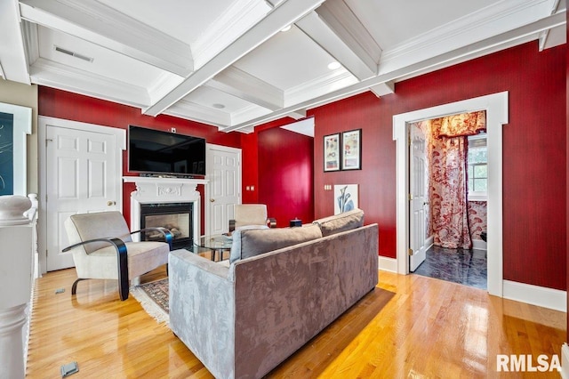 living room with beam ceiling, ornamental molding, coffered ceiling, and hardwood / wood-style floors