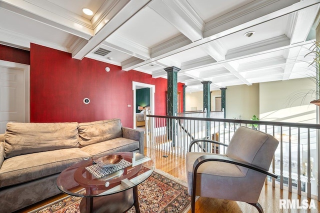 living room with hardwood / wood-style flooring, beam ceiling, crown molding, and coffered ceiling