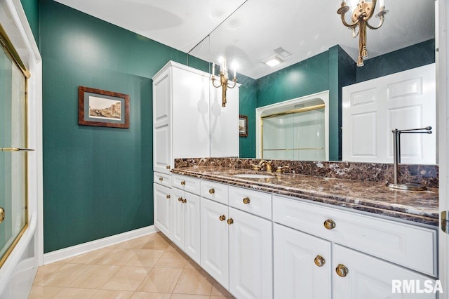 bathroom with tile patterned flooring, vanity, and enclosed tub / shower combo