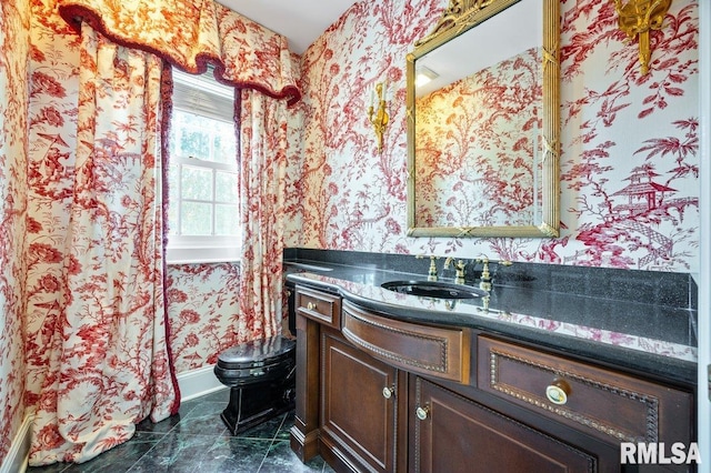 bathroom featuring vanity and toilet