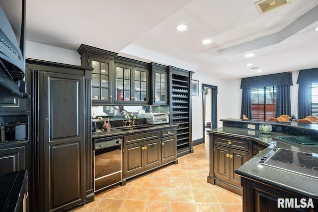 kitchen with a raised ceiling, sink, light tile patterned floors, black dishwasher, and cooktop