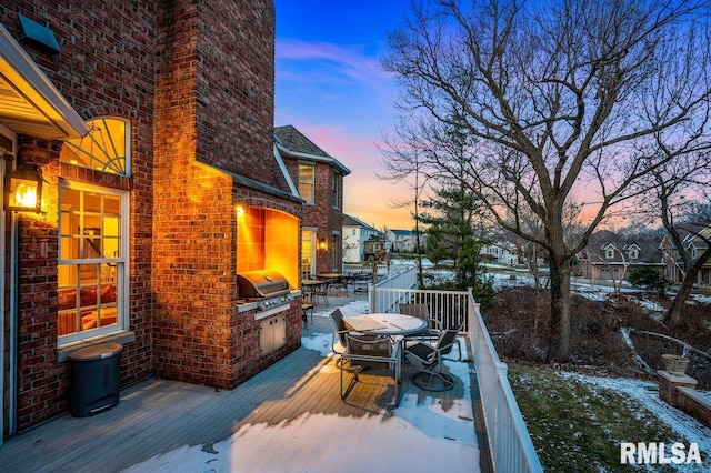 snow covered deck with grilling area