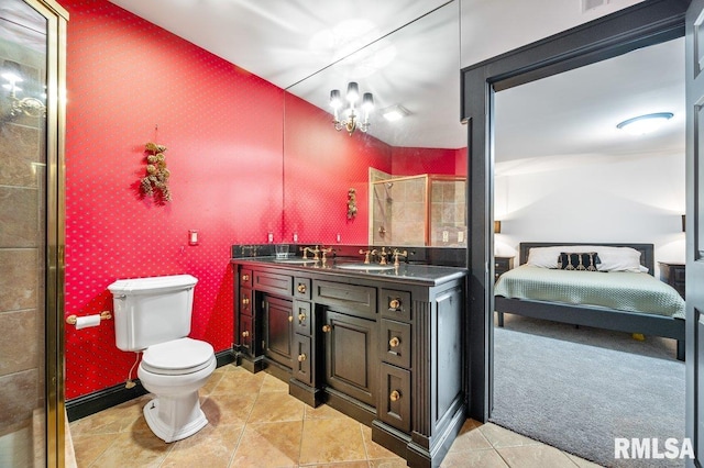 bathroom featuring tile patterned floors, an enclosed shower, vanity, an inviting chandelier, and toilet