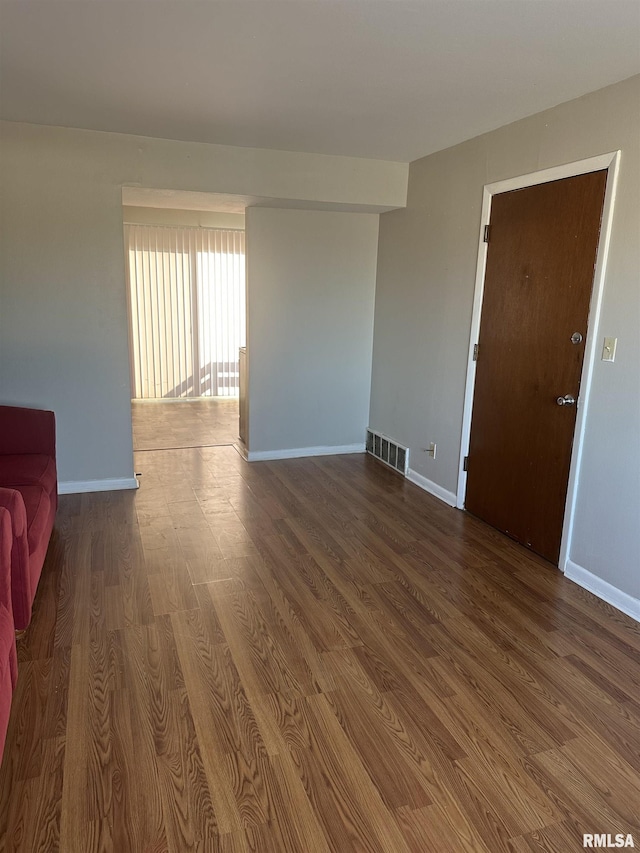 spare room with wood-type flooring