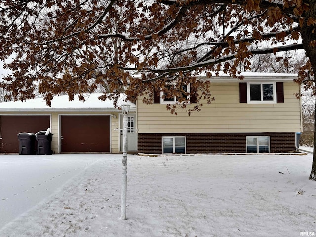 tri-level home featuring brick siding