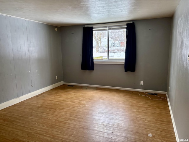 spare room featuring light hardwood / wood-style flooring