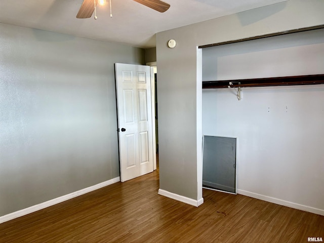 unfurnished bedroom featuring dark hardwood / wood-style flooring, a closet, and ceiling fan