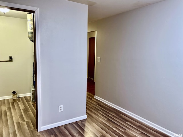 unfurnished bedroom featuring wood finished floors and baseboards