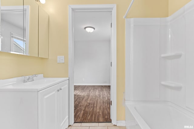 bathroom featuring vanity,  shower combination, and tile patterned flooring