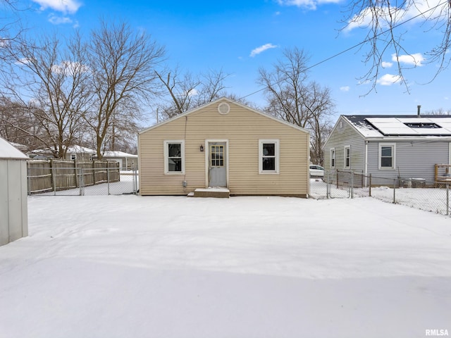 view of snow covered rear of property