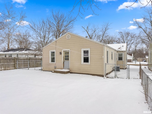 view of snow covered rear of property