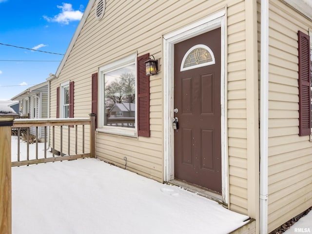 view of snow covered property entrance