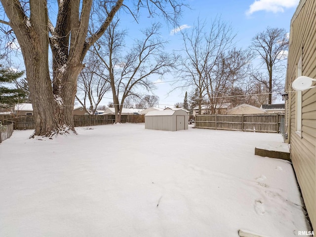 yard covered in snow featuring an outbuilding