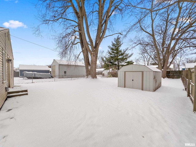 snowy yard with a storage unit